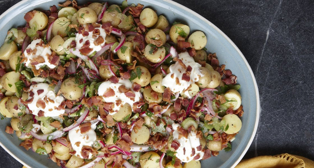 Herby German potato salad with pickled onions, crème fraîche, and whole-grain mustard